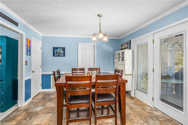 4104 Moss Brook Dr, Winston-Salem, NC 27127 - dining space featuring a textured ceiling, stone finish floor, ornamental molding, and an inviting chandelier