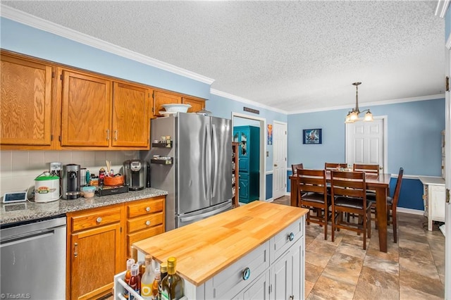 4104 Moss Brook Dr, Winston-Salem, NC 27127 - kitchen featuring crown molding, a chandelier, wooden counters, appliances with stainless steel finishes, and brown cabinets