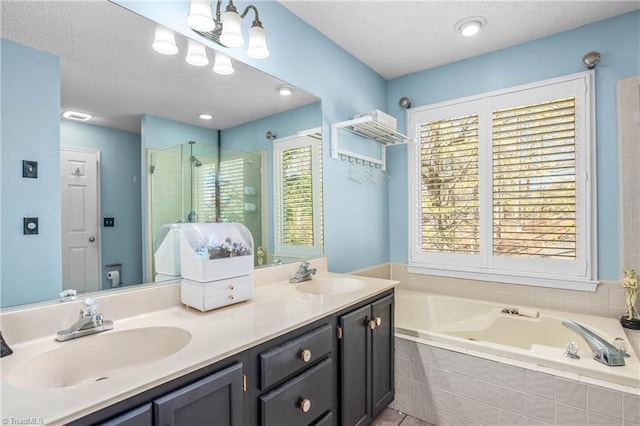 4104 Moss Brook Dr, Winston-Salem, NC 27127 - bathroom featuring a sink, a stall shower, a textured ceiling, and a bath