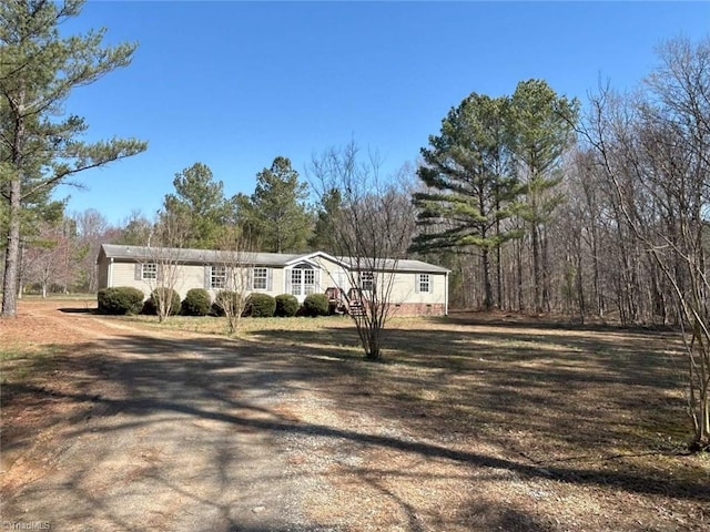 view of front of home featuring a front yard and crawl space