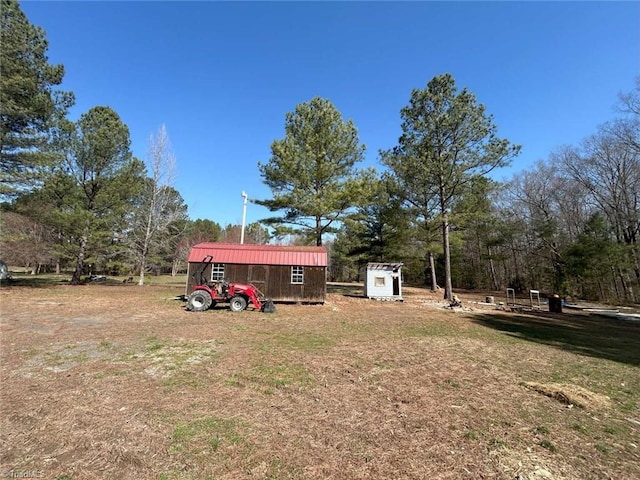 view of yard with an outbuilding and a storage shed