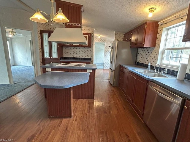 kitchen with a sink, a center island, white appliances, wallpapered walls, and custom exhaust hood