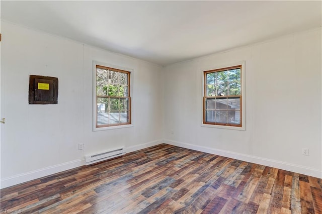 empty room with baseboard heating, baseboards, and wood-type flooring