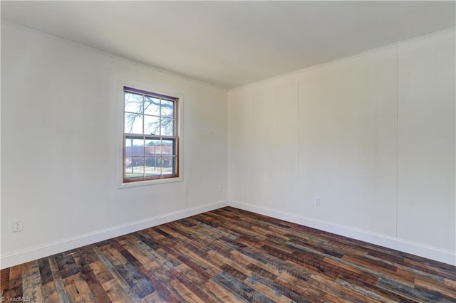 unfurnished room with baseboards and dark wood-style floors