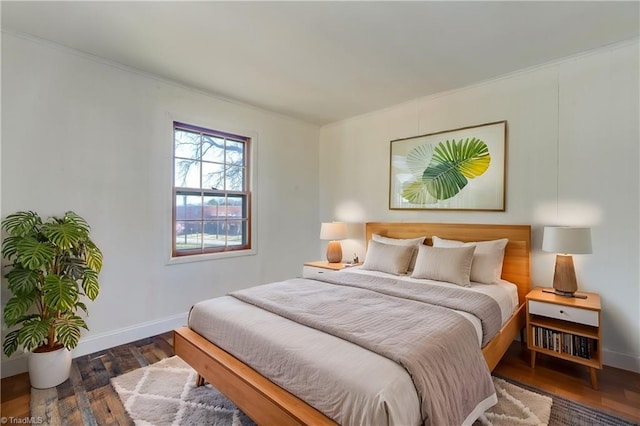 bedroom featuring baseboards and wood finished floors