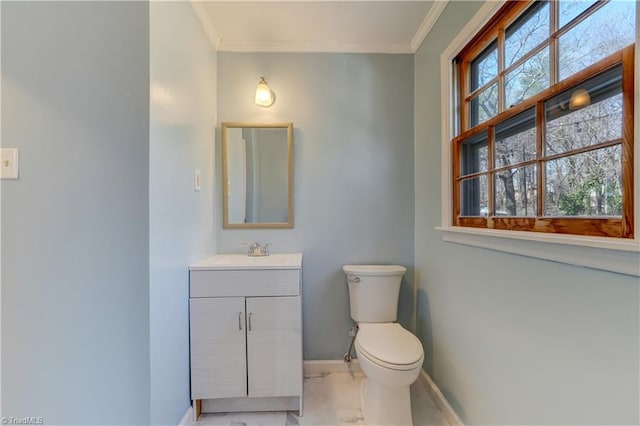 bathroom featuring baseboards, vanity, marble finish floor, and crown molding