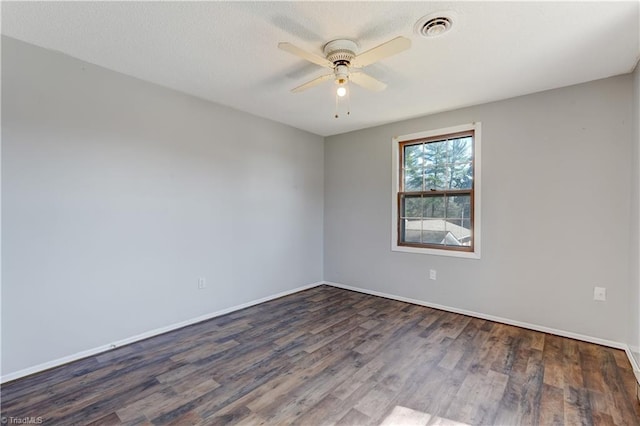 unfurnished room featuring ceiling fan, visible vents, baseboards, and wood finished floors