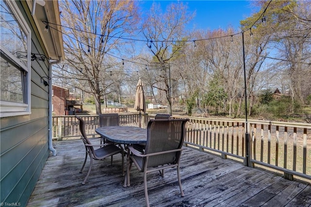 wooden terrace featuring outdoor dining space