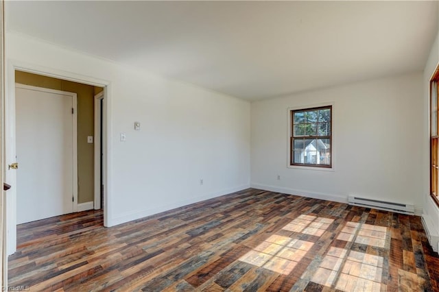 unfurnished room with a baseboard heating unit, wood finished floors, and baseboards