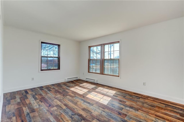 empty room with a baseboard radiator, wood-type flooring, and baseboards