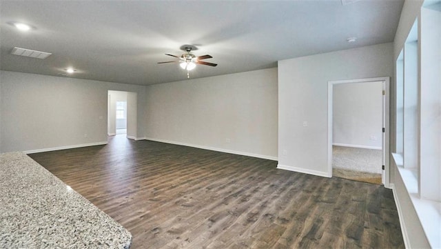 spare room with dark hardwood / wood-style floors and ceiling fan