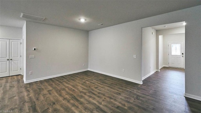 spare room with dark wood-type flooring