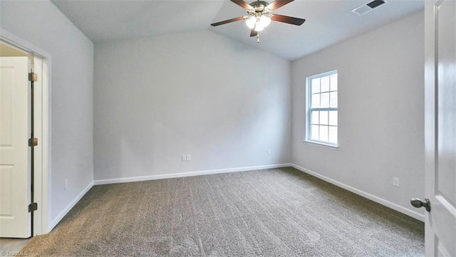 carpeted spare room featuring lofted ceiling and ceiling fan