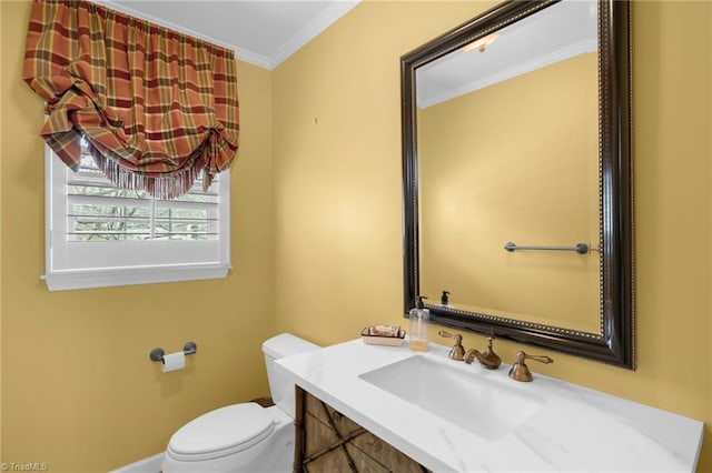 bathroom featuring ornamental molding, vanity, and toilet