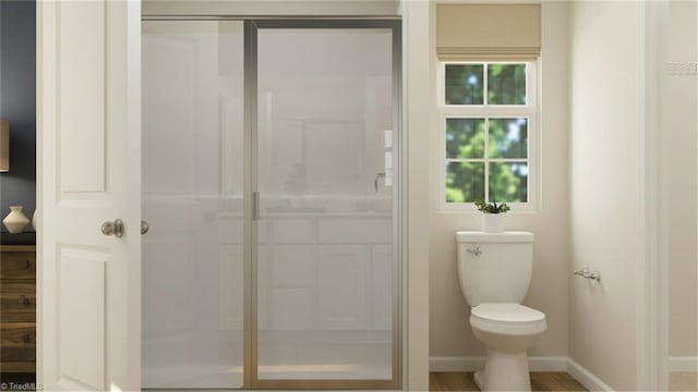 bathroom with a shower, toilet, and baseboards