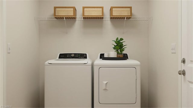 clothes washing area featuring laundry area and washer and dryer