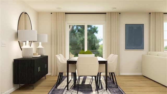 dining room featuring light wood finished floors and baseboards