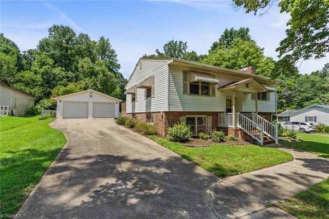 split foyer home with an outbuilding, a front lawn, and a garage