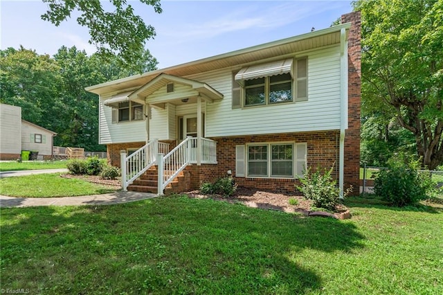 raised ranch with a front yard