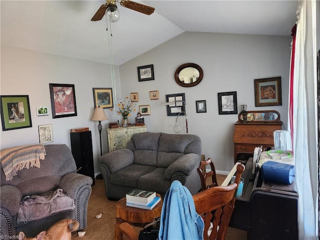 living room featuring ceiling fan, wood-type flooring, and vaulted ceiling