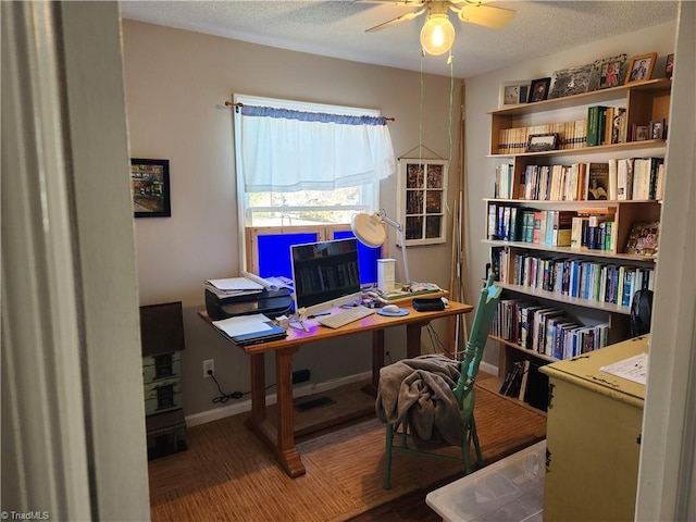 office with a textured ceiling, ceiling fan, and dark wood-type flooring