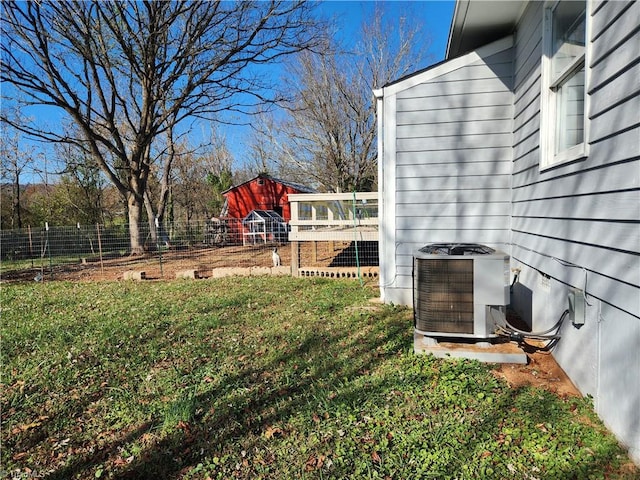 view of yard featuring central AC unit and an outdoor structure