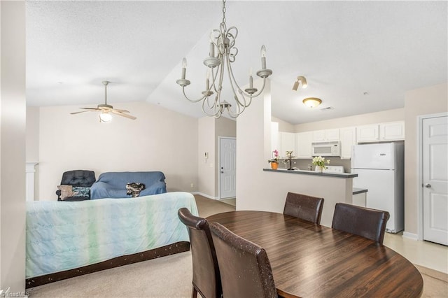 dining room with ceiling fan with notable chandelier, vaulted ceiling, and light carpet