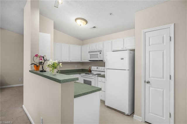 kitchen featuring vaulted ceiling, white cabinets, white appliances, kitchen peninsula, and a textured ceiling