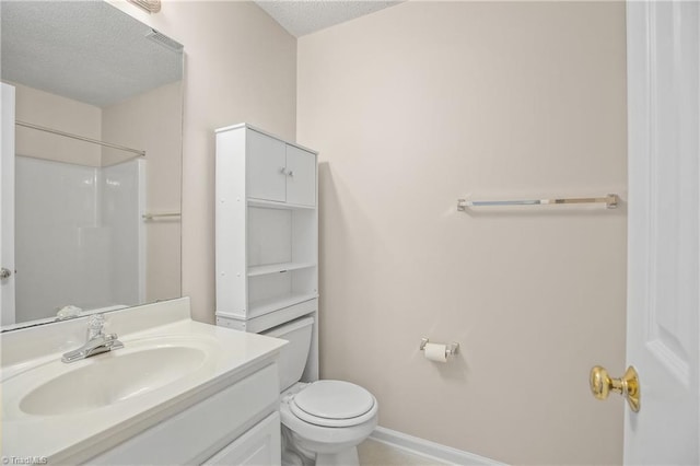 bathroom featuring walk in shower, vanity, toilet, and a textured ceiling