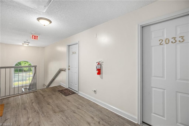 interior space featuring a textured ceiling and hardwood / wood-style flooring