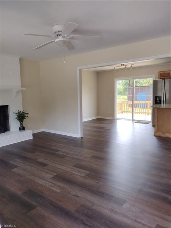 251 Marshall Farm Rd, Mount Airy, NC 27030 - unfurnished living room with dark wood-type flooring, a ceiling fan, and a fireplace