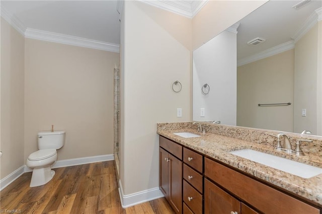 bathroom featuring visible vents, wood finished floors, a sink, and toilet