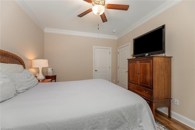 bedroom featuring a ceiling fan, crown molding, baseboards, and wood finished floors