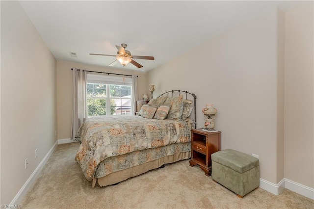 bedroom featuring a ceiling fan, light colored carpet, visible vents, and baseboards