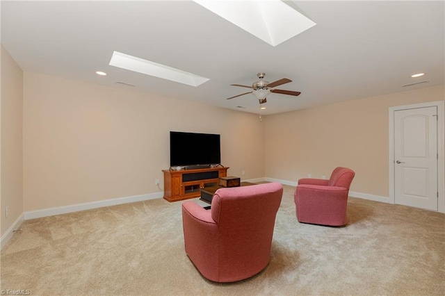 living area featuring a skylight, carpet, baseboards, and recessed lighting