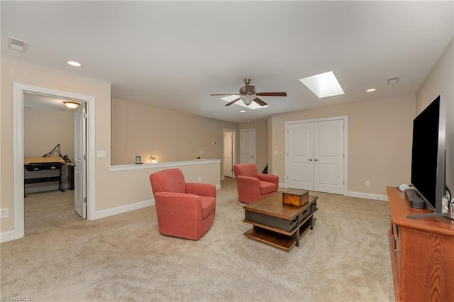 living room with a skylight, baseboards, visible vents, carpet floors, and recessed lighting