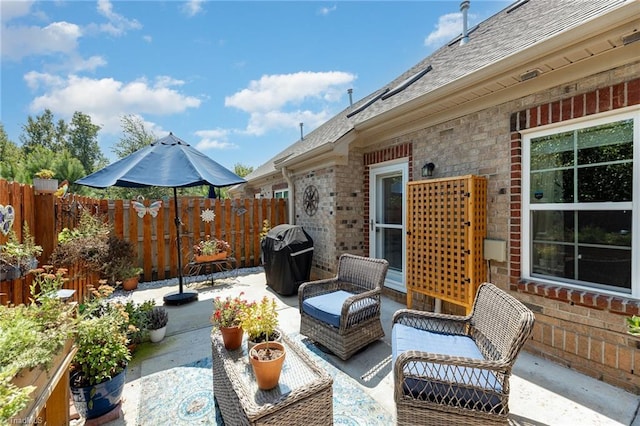 view of patio / terrace featuring fence and grilling area