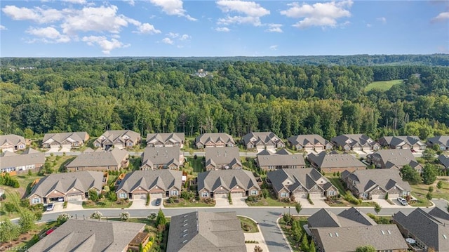 birds eye view of property with a residential view and a wooded view