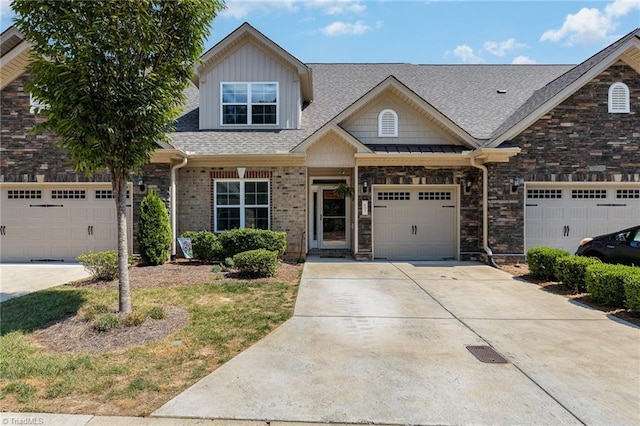 view of front of house featuring roof with shingles, driveway, brick siding, and an attached garage