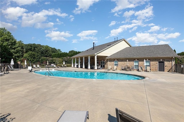 pool featuring a patio area and fence