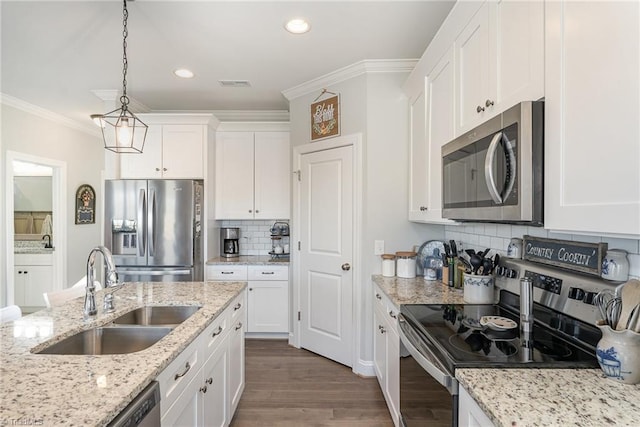 kitchen featuring stainless steel appliances, light stone counters, a sink, and white cabinets