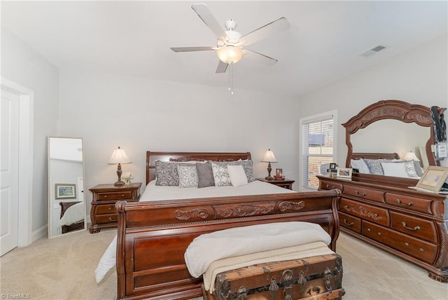 bedroom with a ceiling fan, visible vents, and light carpet