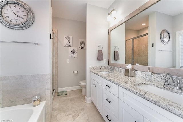 bathroom featuring marble finish floor, a sink, a shower stall, and baseboards