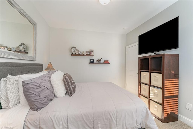 bedroom featuring baseboards and light colored carpet