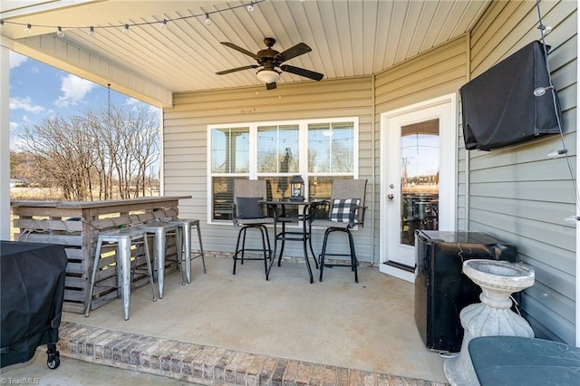 view of patio featuring ceiling fan, outdoor dining space, outdoor dry bar, and area for grilling