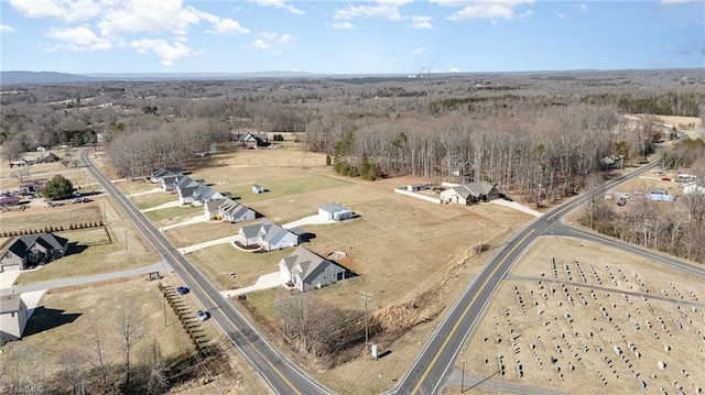 birds eye view of property with a forest view
