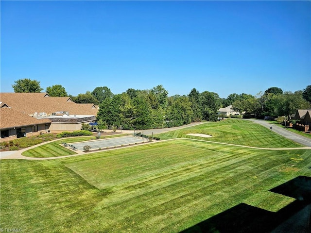 view of property's community featuring a yard