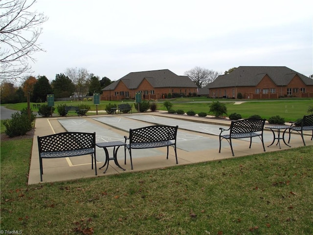 view of home's community featuring a lawn and a patio area