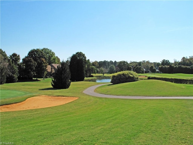 view of home's community featuring a yard and a water view