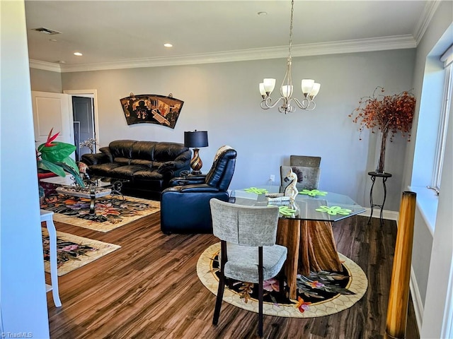 dining area featuring wood-type flooring, crown molding, and a notable chandelier